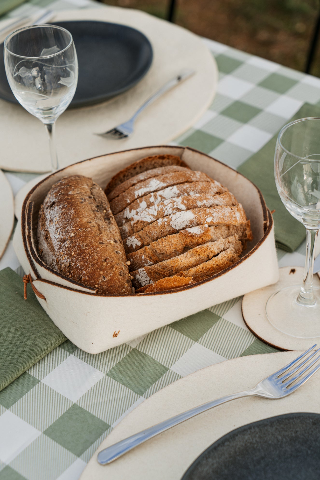 Rustic table setting with natural wool basket, sustainable tableware for countryside homes and boutique hotels