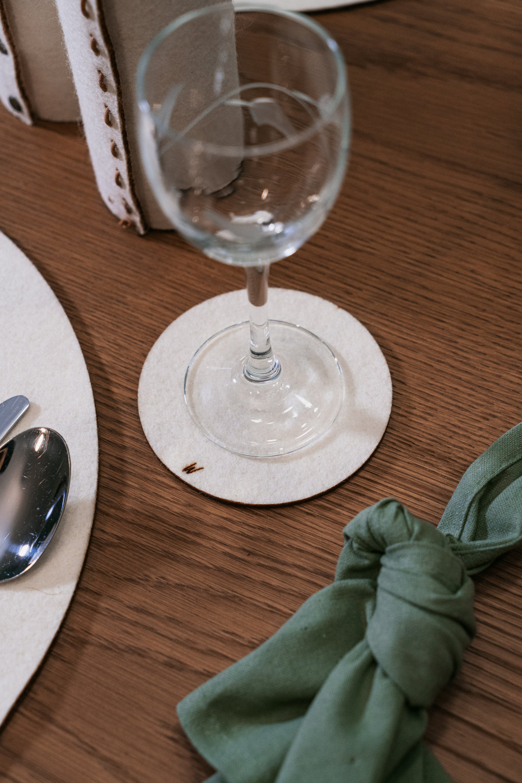 Handmade wool coasters on refined table setting, natural decor for hospitality and boutique hotel interiors