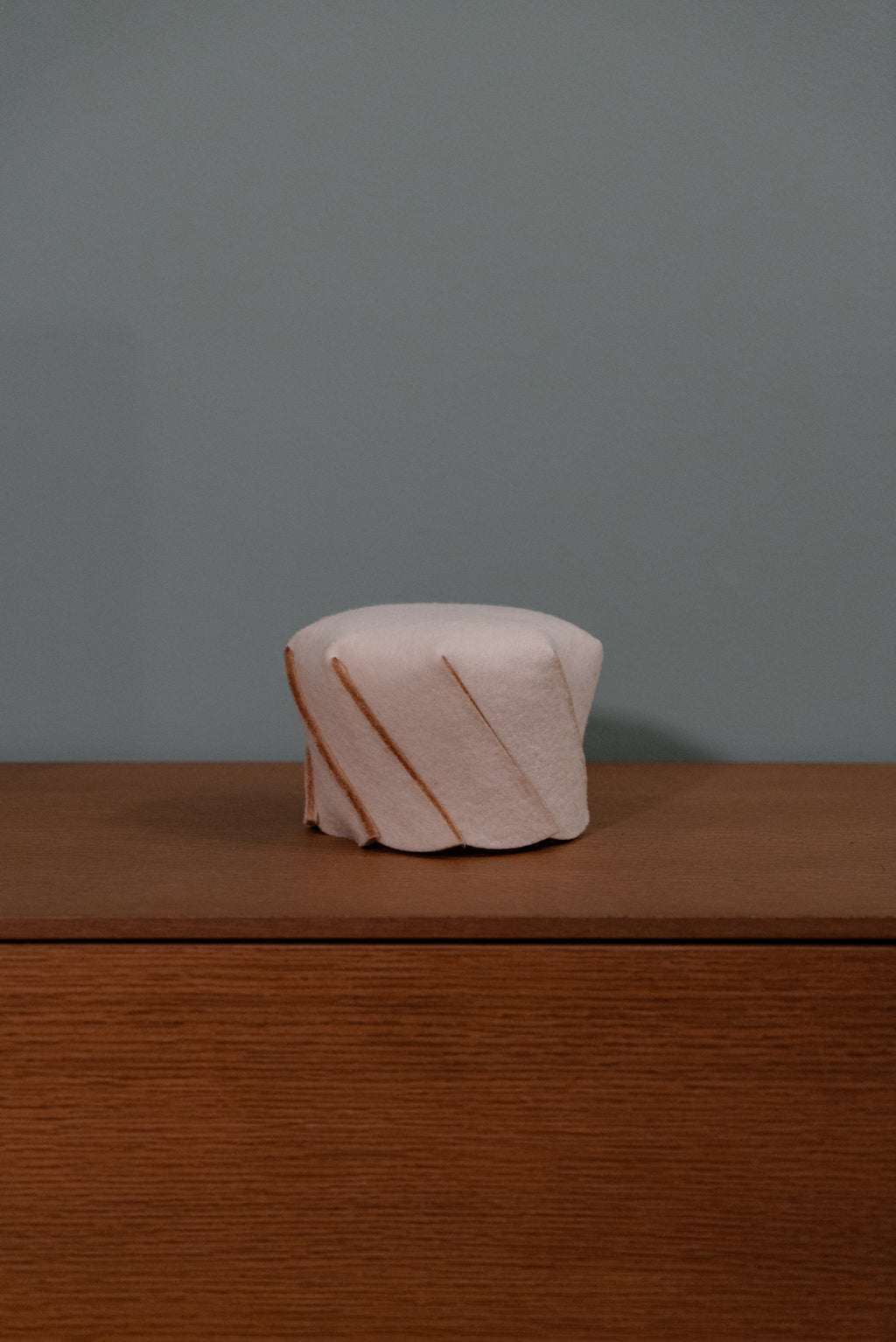 Minimalist bedside table with wool lamp, natural lighting for warm interiors and boutique hotel design