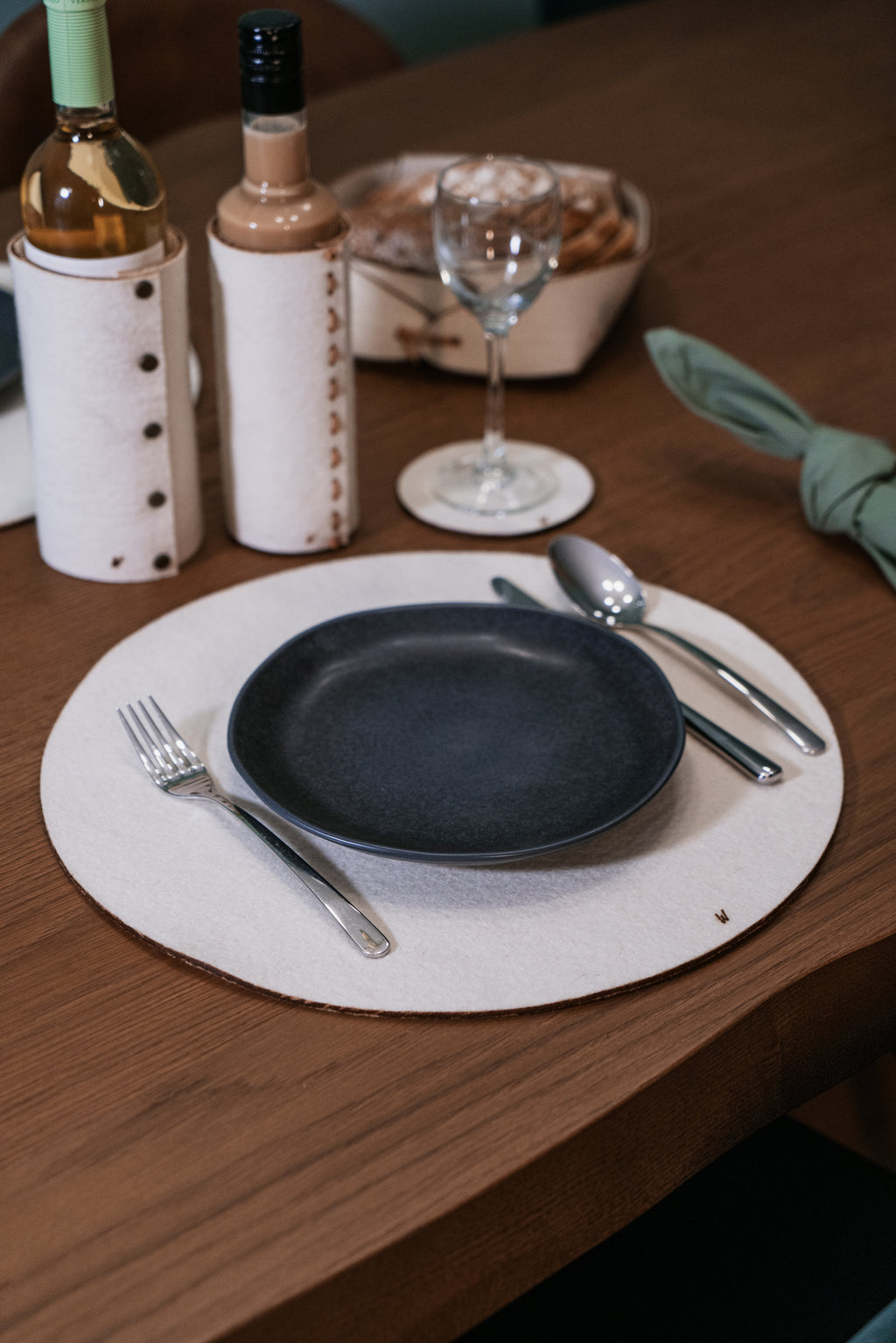 Minimalist table setting with natural wool placemats, eco friendly tableware for interiors and hotels