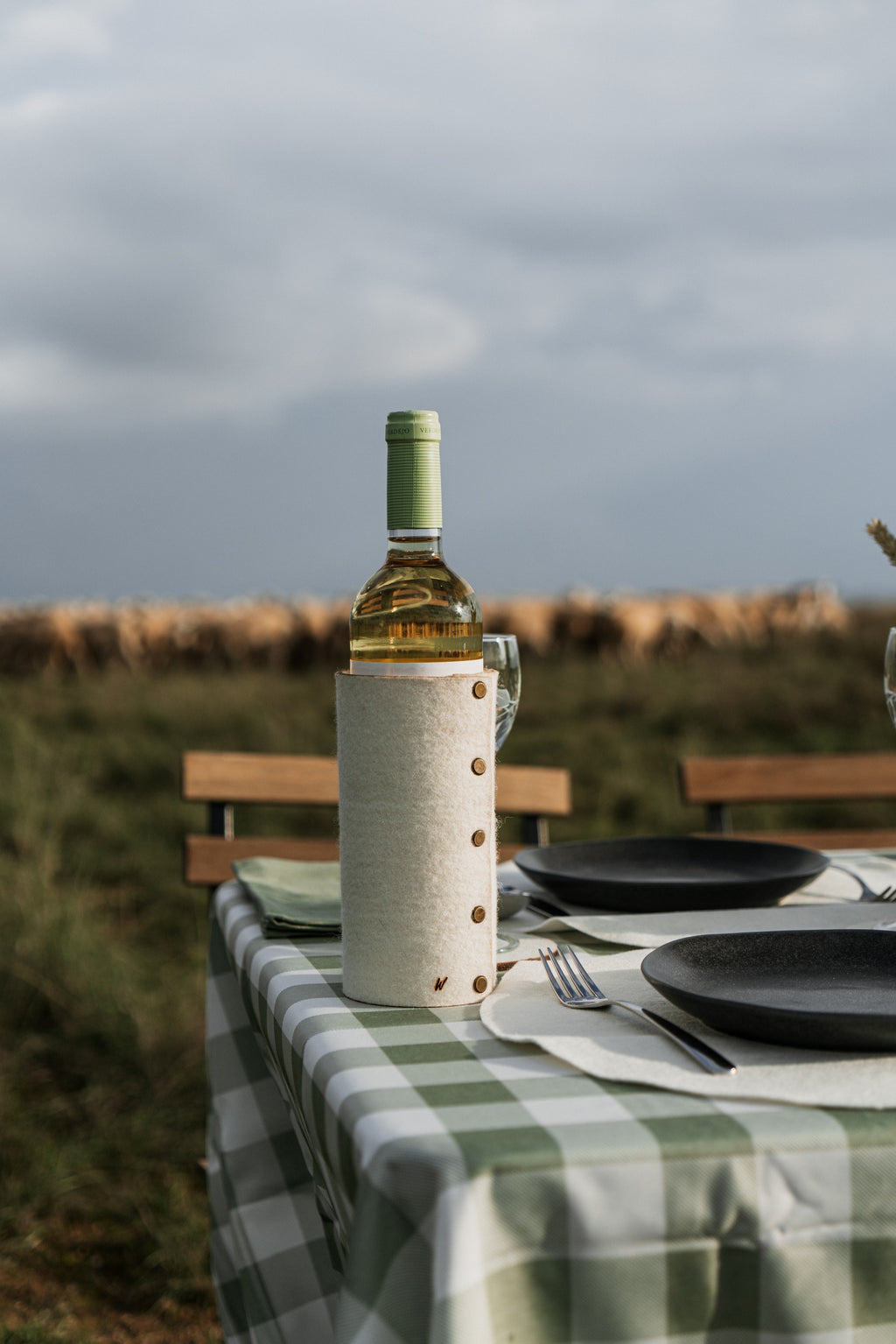 Natural wool bottle sleeve for wine on slow living outdoor table setting